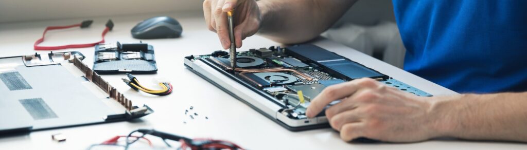 IT technician repairing a computer