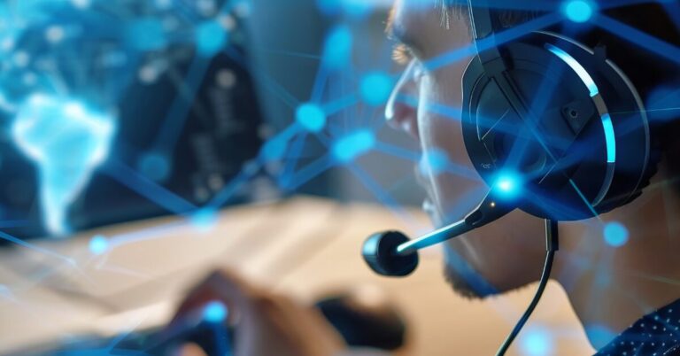 Man with headset looking at a computer screen